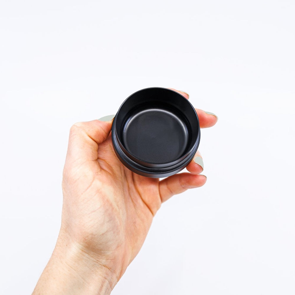 flowermill 2.5 premium herb grinder bowl in the hand of a user on white background