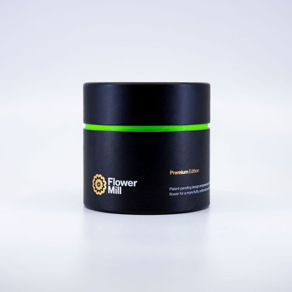black white and green flowermill herb grinder packaging on white background