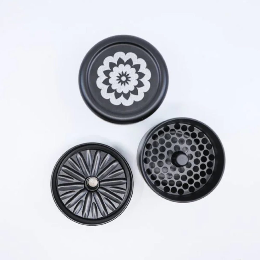 black and grey flowermill 2.5 standard herb grinder with white flowermill branding in 3 separate sections with top view on white background