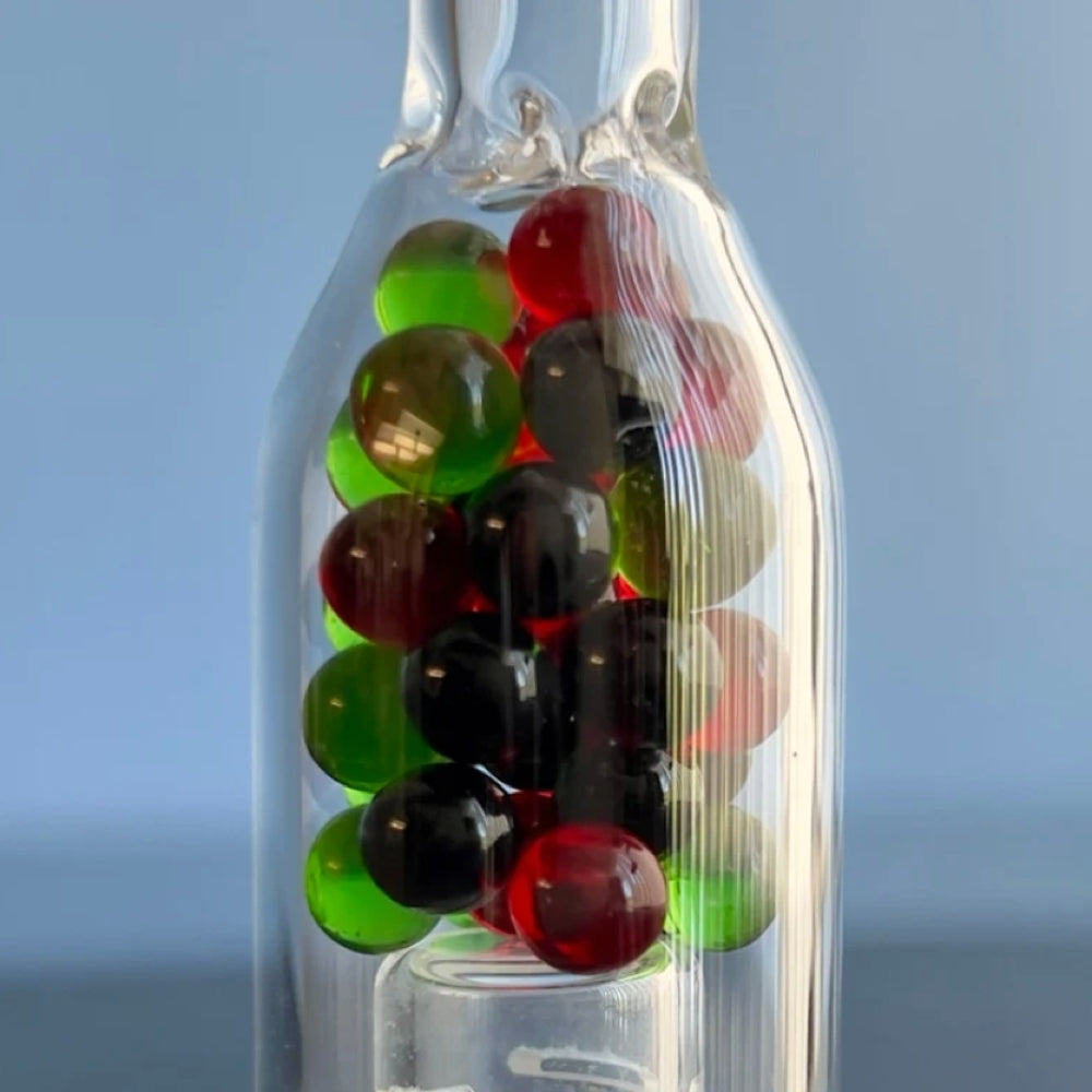 close up of multi coloured glass beads inside the sneaky pete XL rocket stem for use with storz & bickel crafty+ & mighty+ vaporizers