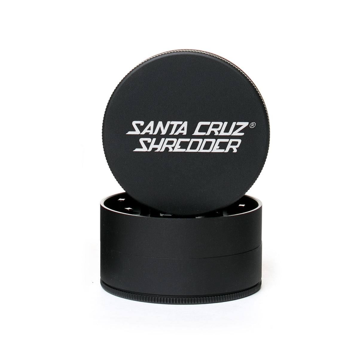 large matt black santa cruz shredder herb grinder with the lid section sitting on top of the base. Santa Cruz logo on lid.