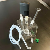 sneaky pete mega cube glass rig paired with healthy rips rogue vaporizer sat on grey surface