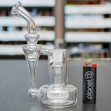 sneaky pete sidepiece 14mm glass rig sat on grey surface