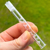sneaky pete glass 3d add-a-cap in users hand with green background