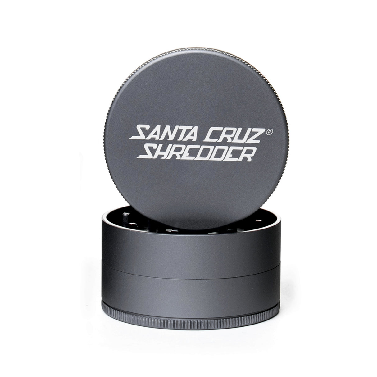 Grey 3 piece santa cruz shredder herb grinder with the lid section sitting on top of the base. Santa Cruz logo on lid.