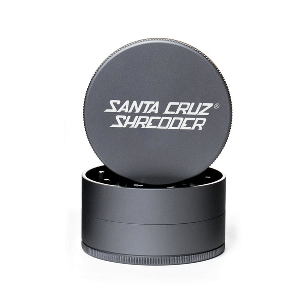 Grey circular 2 piece herb grinder with the lid section sitting on top of the base. Santa Cruz logo on lid.