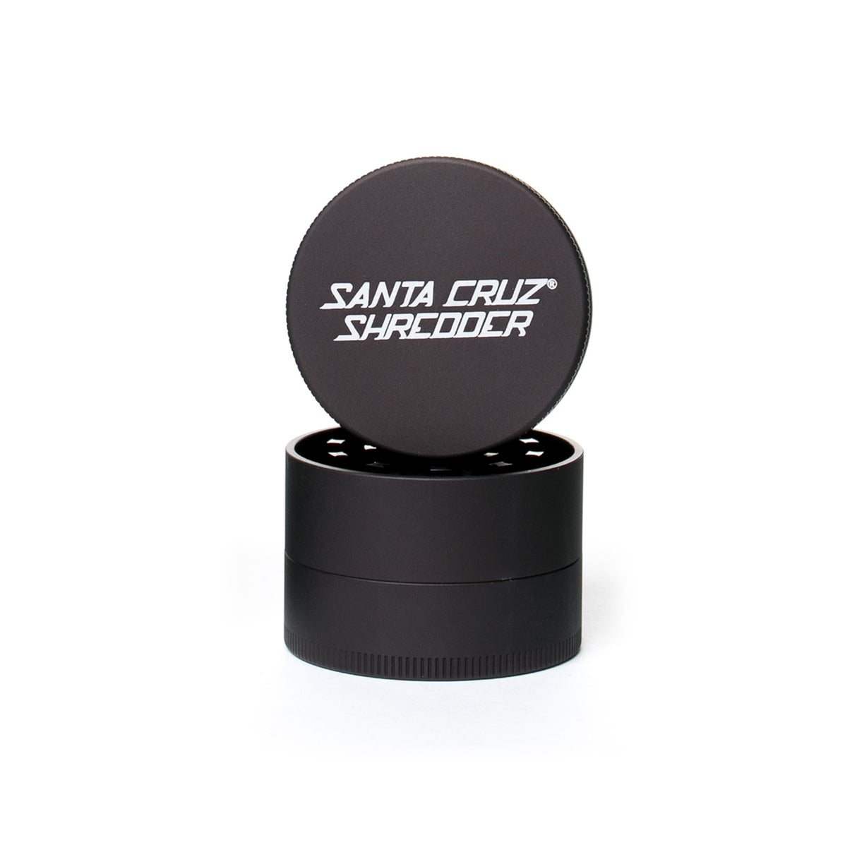 medium matt black 4 piece santa cruz shredder herb grinder with the lid section sitting on top of the base. Santa Cruz logo on lid.